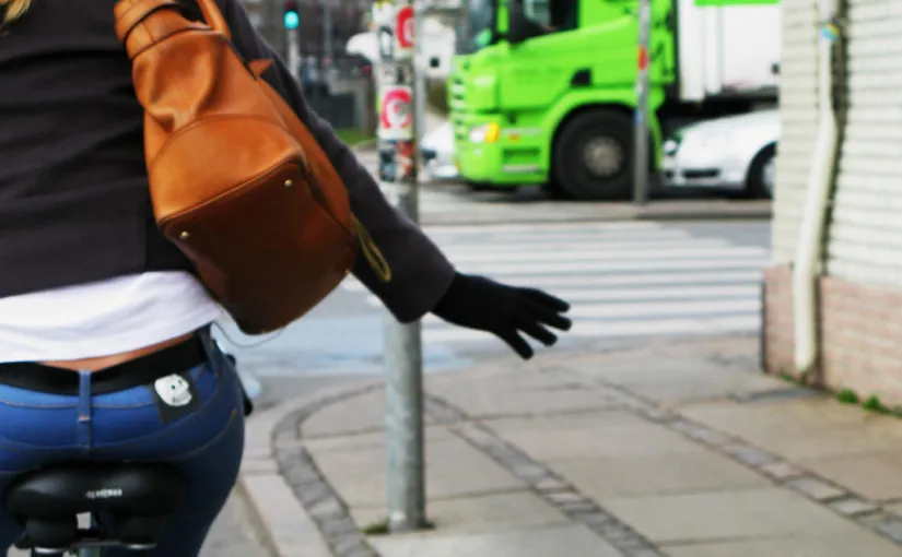 cyclist making right hand turn signal