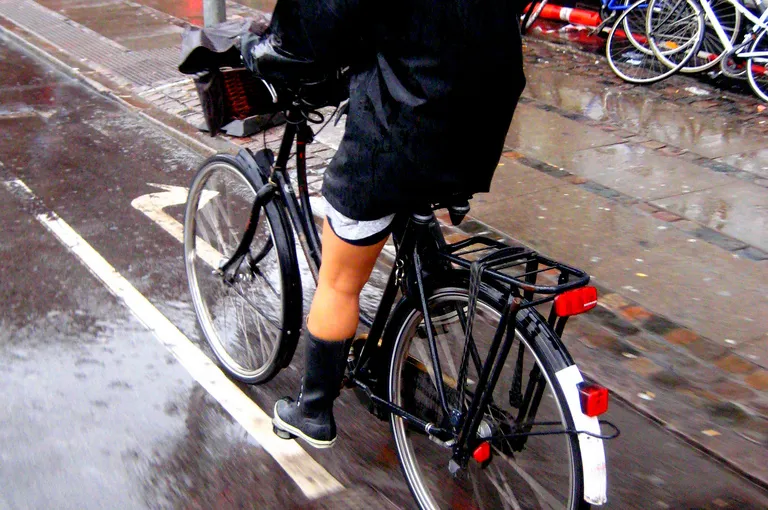 Person riding practical bike in the rain