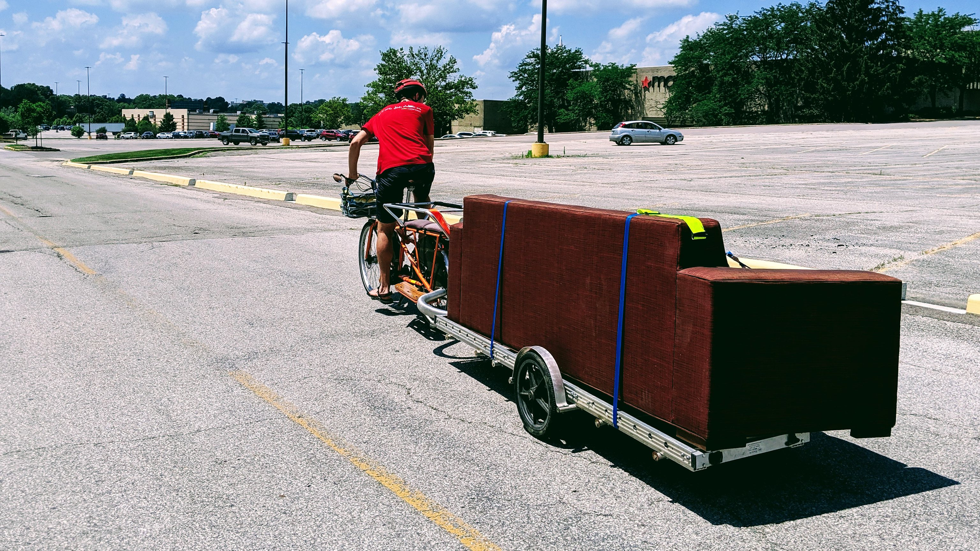 8 foot long couch towed behind electric Yuba Mundo. 