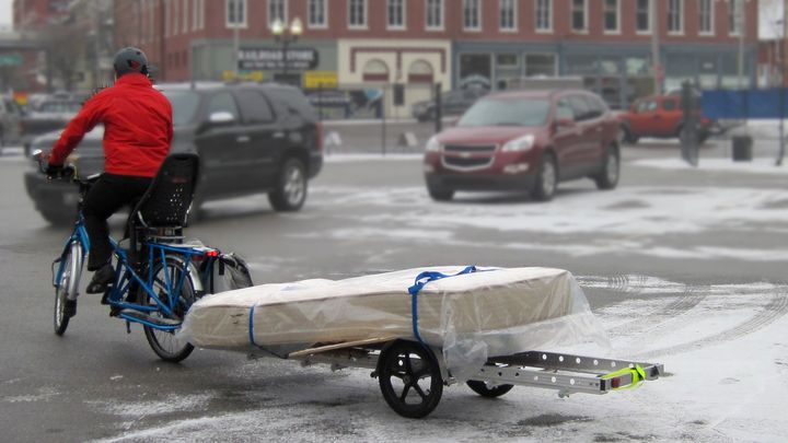 Carrying a twin size mattress on a bike trailer behind an electric cargo bike.